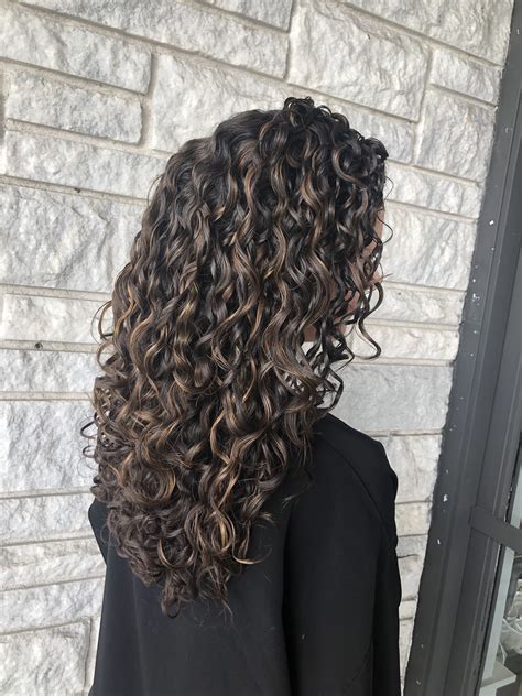 dark hair with brown highlights|dark brown curly hair with highlights.